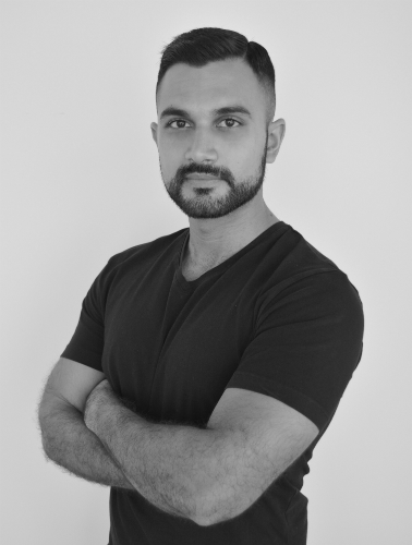 a black-and-white picture of a man with arms crossed