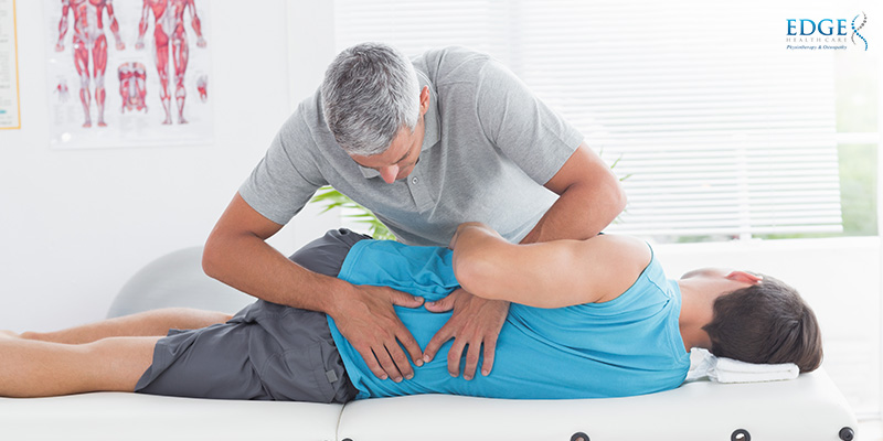 Physiotherapist Treating A Patient With Back Pain